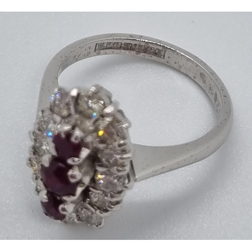 235 - 18ct white gold ring of twelve diamonds and three rubies.  7.4g approx.  Size N1/2.   (B.P. 21% + VA... 