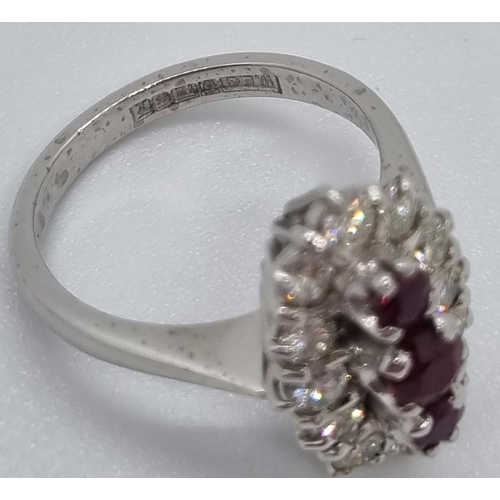 235 - 18ct white gold ring of twelve diamonds and three rubies.  7.4g approx.  Size N1/2.   (B.P. 21% + VA... 