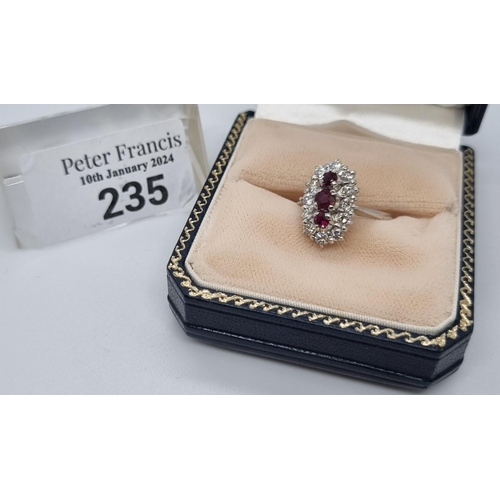 235 - 18ct white gold ring of twelve diamonds and three rubies.  7.4g approx.  Size N1/2.   (B.P. 21% + VA... 