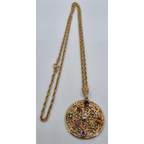 253 - 9ct gold pierced circular pendant inset with multicoloured semi-precious stones on a 9ct gold chain.... 