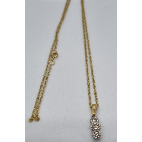 254 - 9ct gold three stone diamond drop pendant on 9ct gold chain.  2.5g approx.   (B.P. 21% + VAT)