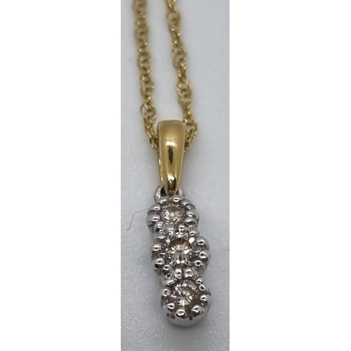 254 - 9ct gold three stone diamond drop pendant on 9ct gold chain.  2.5g approx.   (B.P. 21% + VAT)