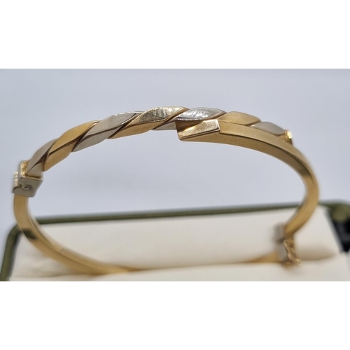 264 - 9ct gold bicolour ladies bangle in fitted box.  7.4g approx.   (B.P. 21% + VAT)