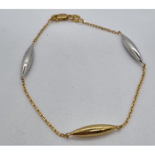 276 - 9ct gold and silver oval design bracelet.  2g approx.  In Burgess Jewellers box.   (B.P. 21% + VAT)