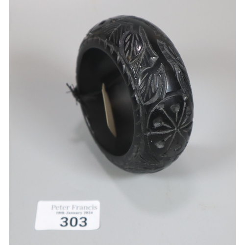 303 - Whitby Jet carved bangle.  (B.P. 21% + VAT)