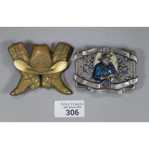 306 - Two American belt buckles, one solid brass in the form of cowboy boots and one Smith and Wesson.  (2... 