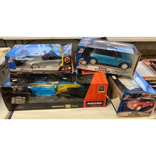 381 - Collection of four radio controlled vehicles, to include: Renault Formula 1 car, two Mini Coopers an... 