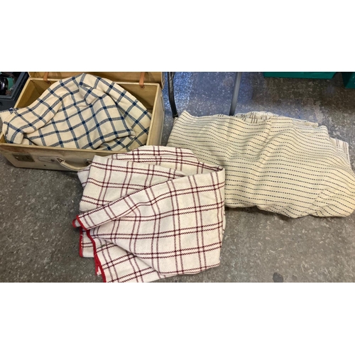 387 - A vintage suitcase containing four vintage cream ground striped or check woollen blankets; two narro... 