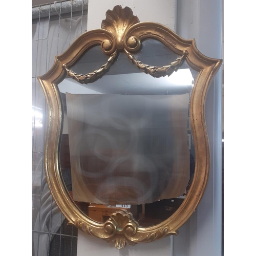 413 - Modern gilt framed shield shaped mirror with shell pediment, swags and scrolls.  61x48cm approx.  (B... 