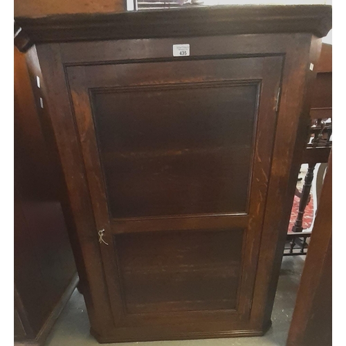 435 - 19th century oak single door blind panelled hanging corner cupboard, the interior revealing two pine... 