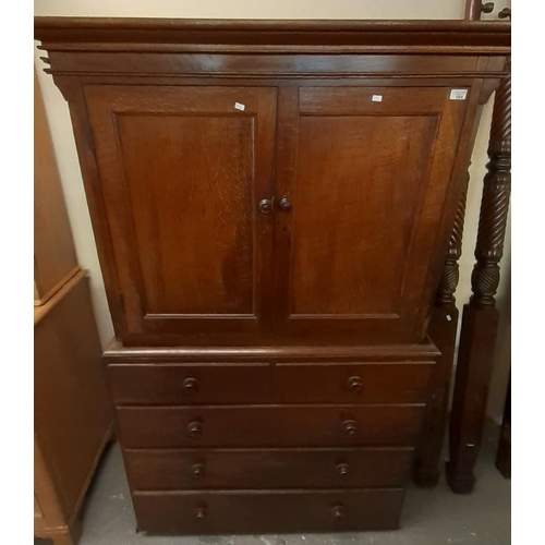 504 - Early 19th century oak two stage press cupboard, the moulded cornice above two blind panelled doors,... 