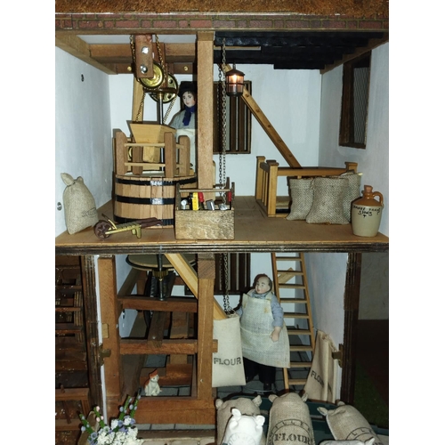 557 - Well made and attractive collector's dolls house in the form of a thatched 17th century Mill House, ... 