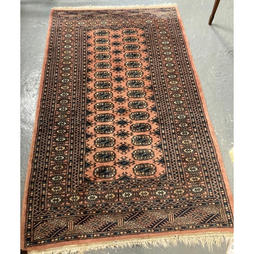 571 - Middle Eastern design salmon ground floral and geometric runner with central repeating tarantula des... 