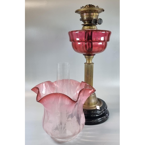 75 - Early 20th Century double oil burner lamp, having cranberry etched glass foliate shade above a cranb... 