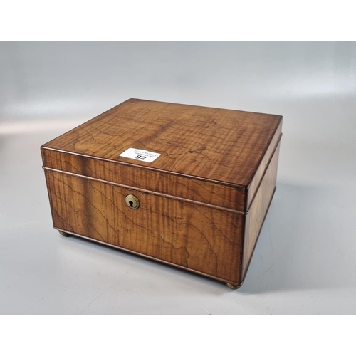 92 - Dunhill, a burr wood table cigar box, with milk glass lining, standing on four brass ball feet, mark... 