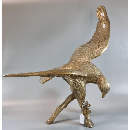 107 - Brass sculpture of an eagle with outstretched wings,  alighting on a branch.  55cm wide approx.   (B... 