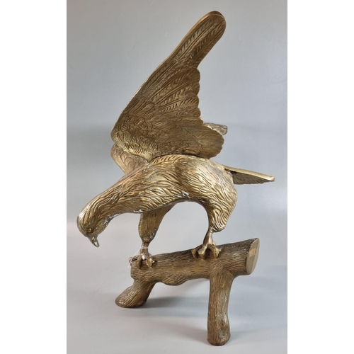 107 - Brass sculpture of an eagle with outstretched wings,  alighting on a branch.  55cm wide approx.   (B... 