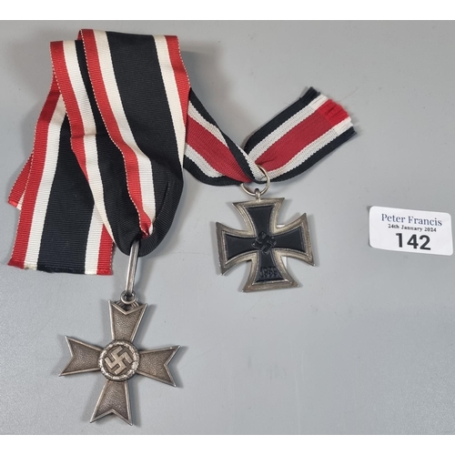 142 - German WWII period Iron cross second class, probably a copy, together with a German 1939 neck cross ... 