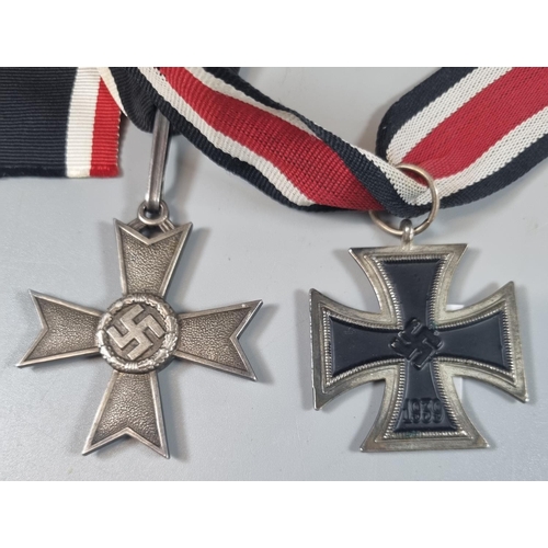 142 - German WWII period Iron cross second class, probably a copy, together with a German 1939 neck cross ... 