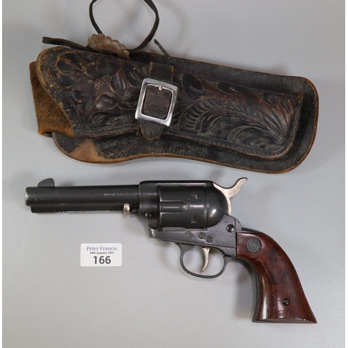 166 - Daisy air pistol in the form of a Colt revolver with worked leather holster. Over 18s only.  (B.P. 2... 