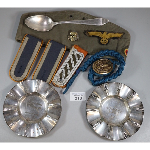 210 - Assorted militaria items to include: German design epaulettes, badges, skull badge, nickel spoon wit... 