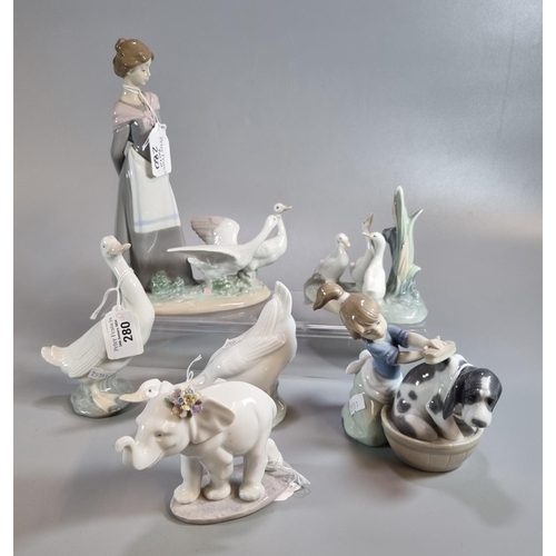 280 - Three Lladro Spanish porcelain figurines to include: girl washing dog (with original box), an elepha... 