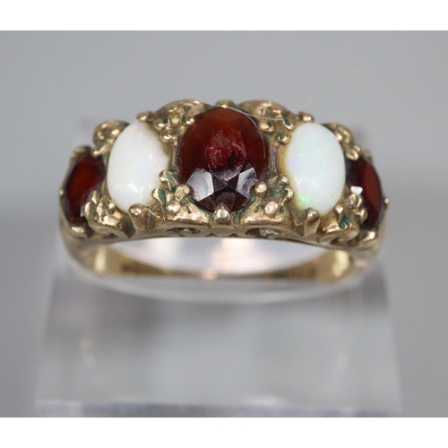 330 - 9ct gold five stone ruby and opal ring.  3g approx.  Size P.   (B.P. 21% + VAT)