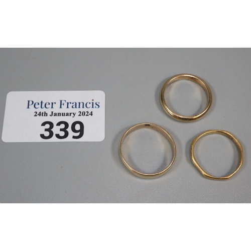 339 - Two 9ct gold wedding bands.  5.3g approx., together with a 22ct gold wedding band.  2.2g approx.   (... 