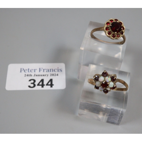 344 - 9ct gold garnet flowerhead ring.  2.8g approx.  Size O.  Together with 9ct gold opal and ruby or gar... 