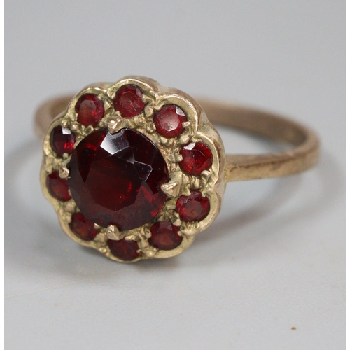 344 - 9ct gold garnet flowerhead ring.  2.8g approx.  Size O.  Together with 9ct gold opal and ruby or gar... 