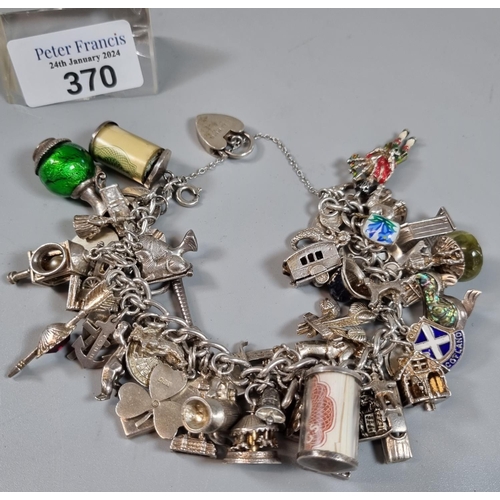 370 - Silver chunky charm bracelet, various charms including: ingot, heart shaped padlock, Ich Dien three ... 