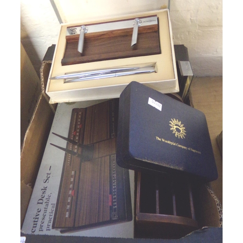 540 - Two boxes of assorted items to include: wooden stationary rack, desk set, binoculars, playing cards ... 