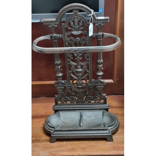 66 - Victorian style cast iron stick and umbrella stand with lift up drip tray.
(B.P. 21% + VAT)