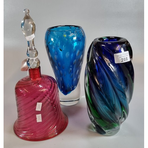 288 - Cranberry glass writhen design hand bell, together with two Murano style blue ground Art glass vases... 