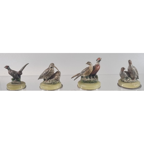 20 - Four cold painted bronze menu holders in the form of  game birds to include: cock pheasant, brace of... 