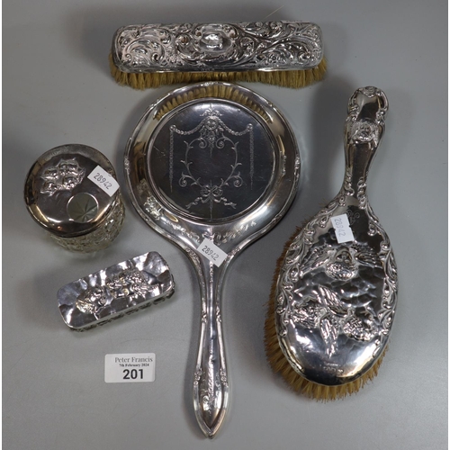 201 - Bag of silver ladies vanity items including: brushes, hand mirror, two glass jars with silver covers... 