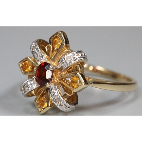 221 - 14ct gold ruby flower head ring.  4.4g approx.  Size S.  (B.P. 21% + VAT)