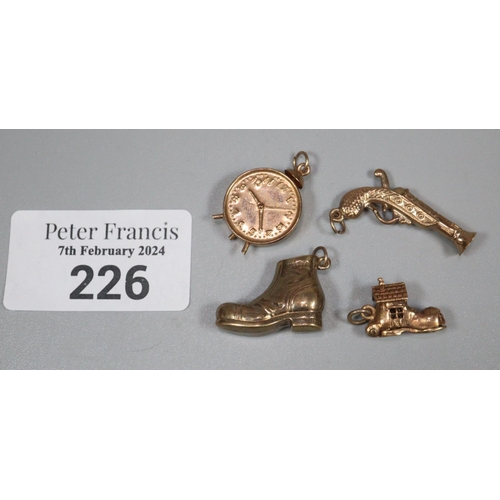 226 - Collection of 9ct gold charms to include: boots, clock, pistol and clock.  6.5g approx.  (B.P. 21% +... 