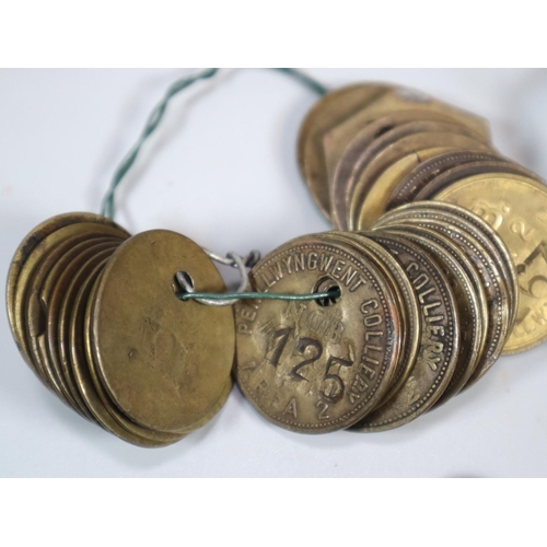 275 - Vintage Huntley & Plamers shortbread tin comprising a large collection of miner's tokens/checks to i... 