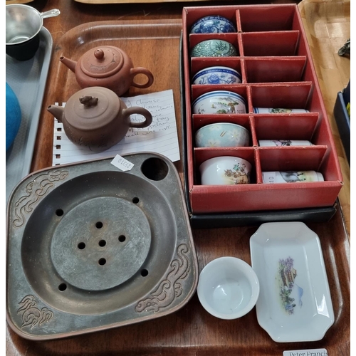 312 - Two trays of Japanese items comprising ceramic bowls with strainers, two ceramic teapots, collection... 