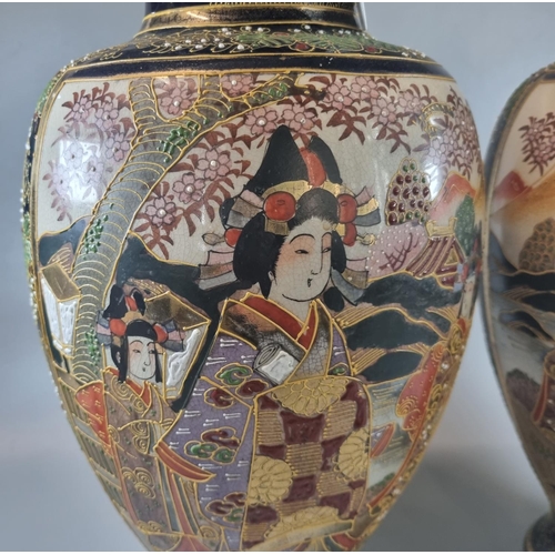 41 - Pair of Japanese Satsuma style vases with polychrome and moriage decorated panels of figures in land... 