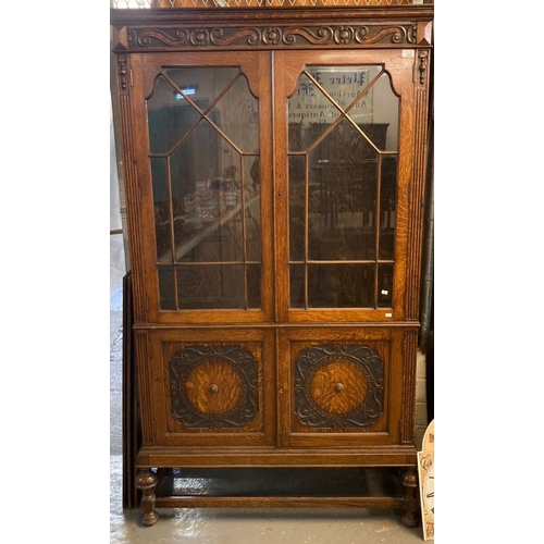 456 - Good quality early 20th century oak glazed bookcase with moulded panel doors below on cup and cover ... 