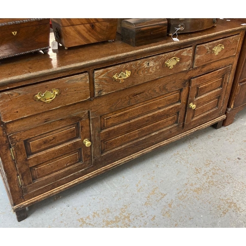 464 - 18th century oak dresser base with three moulded frieze drawers over two raised and fielded panel cu... 