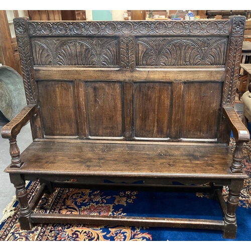 479 - Reproduction 17th century style carved oak, panelled back hall settle with open arms and solid seat.... 