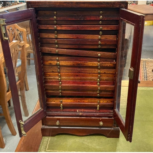 492 - Edwardian mahogany coin collector's cabinet having two glazed doors revealing multiple fitted drawer... 