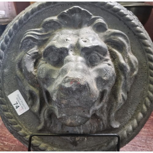 74 - Pair of probably moulded lead male lion head plaques with repeating rope twist decoration. (heavily ... 