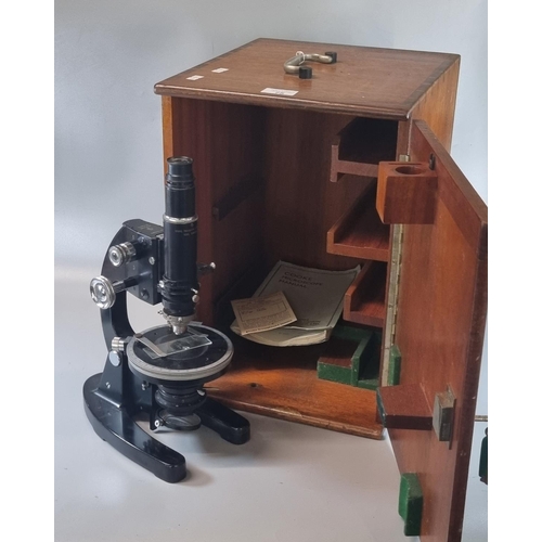 75 - Cooke Troughton & Simms Ltd. cased microscope with serial number M70806 and microscope manual.   (B.... 