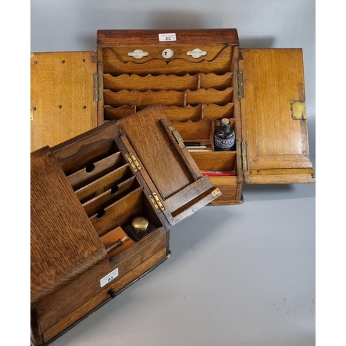 85 - Two similar late 19th early 20th century oak fall front stationary cabinets, both containing various... 