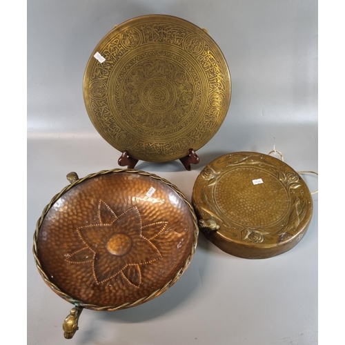 87 - Brass Islamic design dinner gong together with another copper dinner gong decorated with relief styl... 