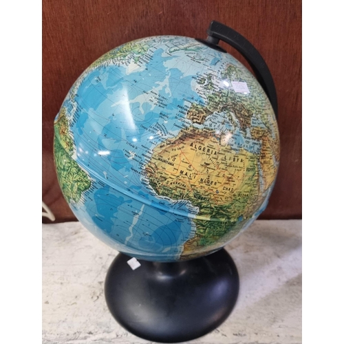 91 - Modern metal table globe on plastic base.